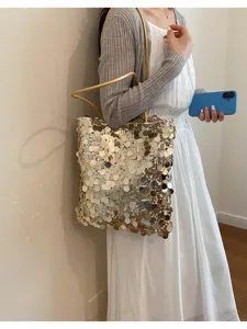 Gold glitter sequin tote bag styled with a white summer dress and grey cardigan
