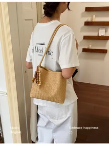 Elegant French style beige woven shoulder bag featuring stylish wooden beaded tassel