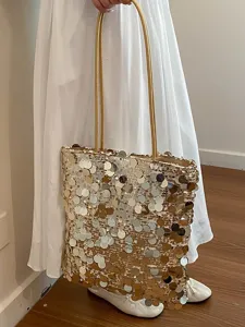 Elegant women's gold sequined tote bag featuring sparkling circular discs for summer fashion