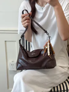 Elegante braune Umhängetasche aus weichem Leder mit einzigartigem Perlenquasten