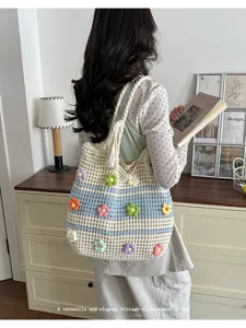 Back view of model carrying a vintage-style knit tote bag with colorful 3D flowers.