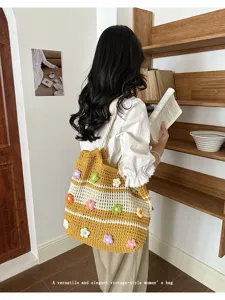 Close-up detail of a woman carrying a yellow 3D flower crochet tote bag in a library