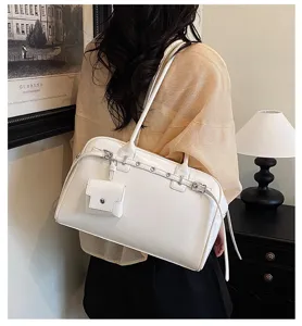 Elegant white soft leather shoulder bag with a decorative belt and mini pouch detail.