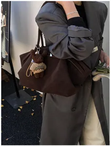 Détail du sac cabas marron vintage avec cordon et pendentif ours mignon