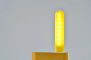 Luce notturna USB portatile con 8 LED, dettaglio della luce calda per comodino e camera letto.