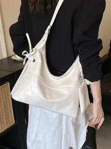 Minimalist white soft leather hobo shoulder bag with a matching small hanging pouch