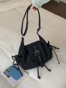 Black nylon flap shoulder bag with buckle strap and drawstring details for commuting