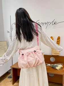 Pink worker-style canvas messenger bag with drawstring and ruffles for summer outfits
