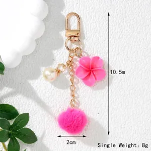 Detailed size view of pink flower pom-pom keychain with dimensions 10.5cm and 8g weight