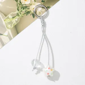 Close-up of cute star and clear bead keychain charm with colorful flower patterns