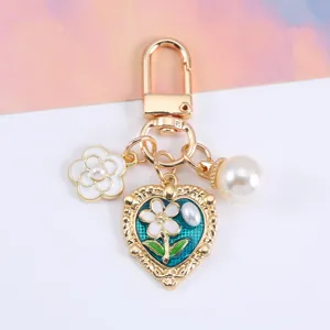 Detailed macro shot of heart and flower keychain with pearl charms for bag decoration