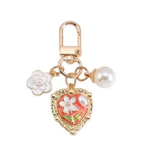 Elegant gold-tone pearl heart flower charm keychain for handbags and airpods cases