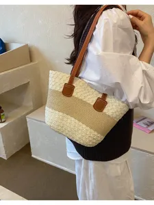 Grand sac cabas en paille tissée bicolore, idéal pour un look estival très élégant.