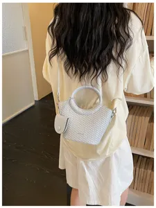 Back view of a light blue woven bucket bag with a stylish round handle for daily commute