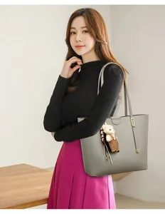 Large grey commuter tote bag with bear charm shown on model for lifestyle detail