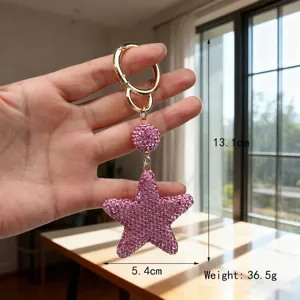 Detailed macro view of pink rhinestone star keychain showing 13.1cm length and 36.5g weight