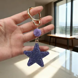 Close-up of purple rhinestone star keychain with sparkling crystal details and gold ring
