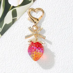 Detailed view of sweet strawberry keychain with rhinestone bow and heart clasp