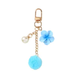 Cute light blue pom-pom and resin flower keychain with pearl charm for bag decor