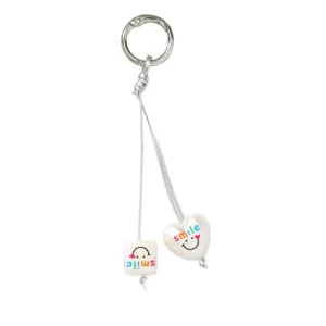 Cute white pearl keychain with heart and square charms featuring rainbow smile design