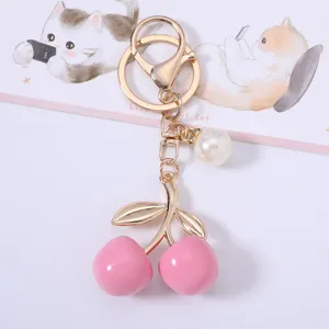 Elegant sweet pink cherry keychain with gold metal leaves and a delicate pearl charm