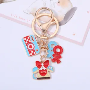 Detailed view of Valentine's Day heart and camera charms on a gold lobster keychain