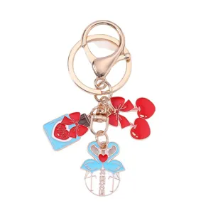 Valentine's Day gold keychain featuring flamingo heart and cherry charms on white