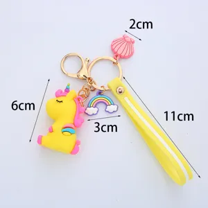 Detailed dimension view of cute yellow unicorn keychain with rainbow and shell charms