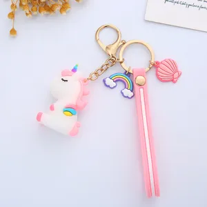 Detailed view of a cute cartoon unicorn keychain with rainbow and pink shell charms