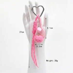 Detail shot of a pink heart-shaped tennis racket keychain with size and weight labels