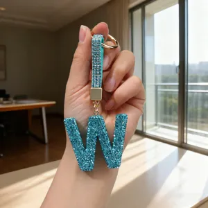 Detailed macro view of a sparkling light blue rhinestone letter W keychain bag charm