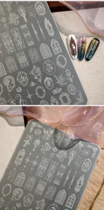 Close-up of Gothic window and angel designs on etched metal nail stamping plate.