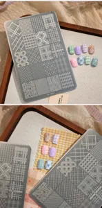 Close-up of TG-002 nail art stamping plate with various retro plaid and houndstooth patterns