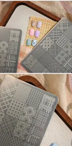 Detailed view of metal nail stamping plate featuring vintage houndstooth and checkered patterns