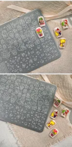 Macro view of TG-021 nail art stamping plate featuring cute cartoon bear and heart designs