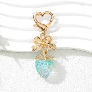 Close-up of sweet UV plated strawberry keychain with rhinestone alloy bow and heart clasp