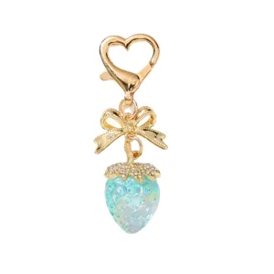 Cute iridescent strawberry keychain with golden bow and heart-shaped clasp charm