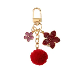 Elegant Japanese cherry blossom keychain with red pom-pom and enamel flower charms