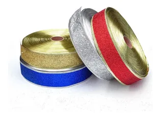 Close-up detail of glittery metallic Christmas ribbons in gold, silver, red, and blue