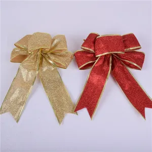 Close-up of gold and red glitter Christmas bows with metallic edges for tree decoration