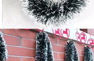 Detailed view of the 2m dark green Christmas tinsel garland with snowy white tips