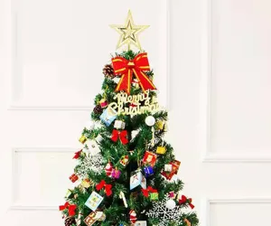 Golden tree top star on a decorated Christmas tree with various festive ornaments