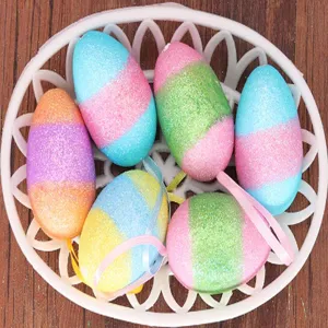 Macro view of glittery multi-colored foam Easter eggs with hanging ribbons in a basket