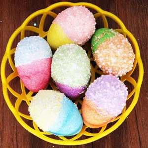 Close-up view of vibrant colorful foam-beaded Easter eggs in a bright yellow basket decor.