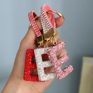 Close-up of sparkling rhinestone alphabet E keychains in red, silver, and pink