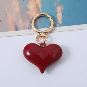 Stylish red acrylic heart-shaped keychain with a gold-tone metal ring for bag decoration