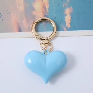 Fashionable blue acrylic heart keychain for bags and car keys with gold clasp.