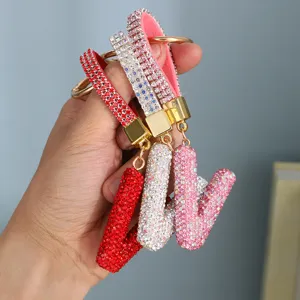 Detail showing sparkling rhinestone-encrusted alphabet keychains in multiple colors