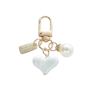 Elegant white pearl and heart-shaped pendant keychain with gold metal clasp for bags