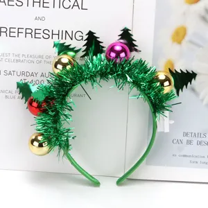 Close-up of Christmas LED headband with green tinsel and colorful metallic balls